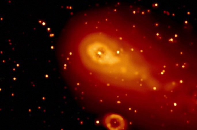 Swift's Ultraviolet/Optical Telescope (UVOT) captured Comet 73P/Schwassmann-Wachmann 3's fragment C as it passed the famous Ring Nebula (oval, bottom) on May 7, 2006. Swift watched as the crumbling comet left dusty blobs behind. nasa, Comet 73P, space, space rock,