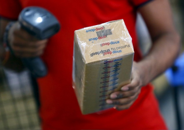 A worker of Indian e-commerce company Snapdeal.com scans barcode on a box after it was packed at the company's warehouse in New Delhi April 20, 2015. snapdeal, snapdeal layoff, snapdeal retrenchment, snapdeal cofounders, crisis at snapdeal, snapdeal news, kunal bahl, rohit bansal