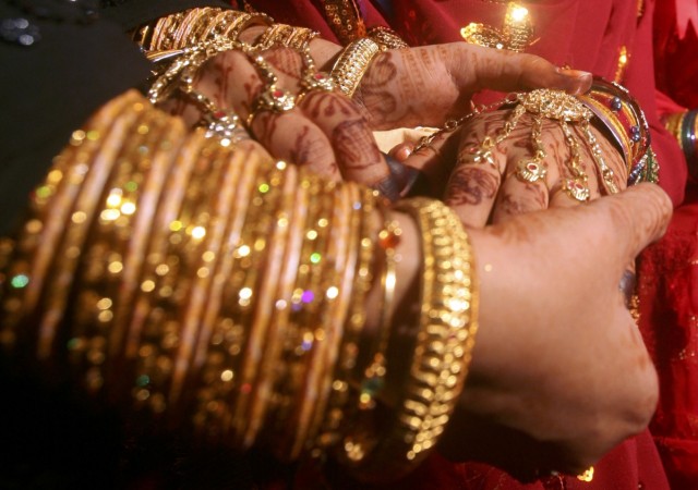 A Muslim bride wears ornaments during a mass wedding ceremony (image for representational purpose only). indian marriages, indian grooms and brides, marriages in india, axis bank merger, axis bank shikha sharma, axis bank share price, kotak mahindra bank