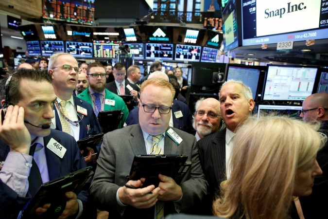 Traders gather on the floor for the IPO of Snap Inc. at the New York Stock Exchange (NYSE) in New York, U.S., March 2, 2017. snap ipo, snapchat app, snap cofounders, snap valuation, snap listing, tech ipos, all you need to know about snap, comments on snap