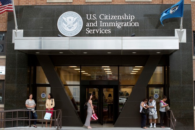 People stand on the steps of the U.S. Citizenship and Immigration Services offices in New York. U.S. Citizenship and Immigration Services