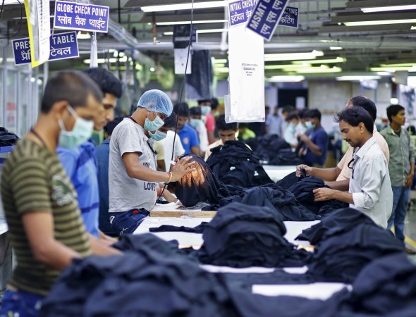 Employees work inside a garment factory of Orient Craft Ltd. at Gurgaon on the outskirts of New Delhi, India, July 3, 2015. global economic outlook march 2017, fitch ratings oulook, india gdp fy2018 outlook, indian economy, chinese economy