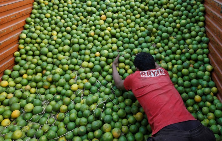 A labourer unloads sweet limes from a truck at a wholesale fruit and vegetable market in Mumbai, India, February 13, 2017. wholesale inflation for february, wpi february, wpi janary, wholesale inflation at record high, inflation in india, indian stock markets