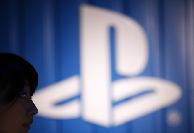 The logo of Sony Corp's PlayStation is seen next to a woman at its booth during the Tokyo Game Show 2014 in Makuhari. Sony PlayStation