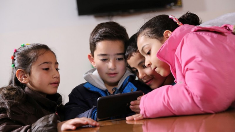 Children playing educational game on a smartphone. Children playing educational game on smartphone