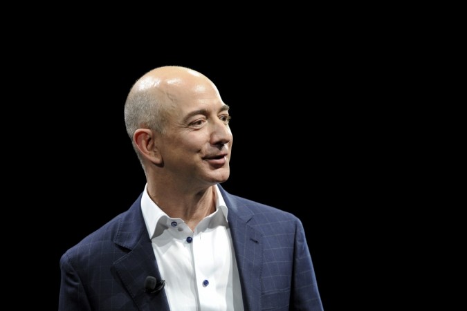 Amazon CEO Jeff Bezos demonstrates the Kindle Paperwhite during Amazon's Kindle Fire event in Santa Monica, California September 6, 2012. Amazon CEO Jeff Bezos, amazon share price, amazon acquires souq