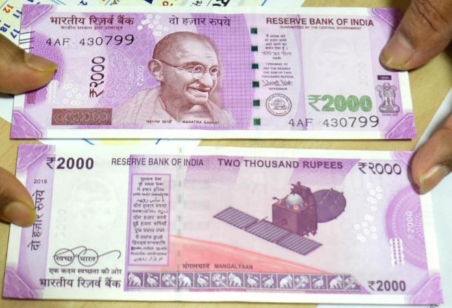 A Bank employee shows Rs 2000 rupee currency notes at the State Bank of India branch in Ranchi on Nov. 10, 2016 rupee