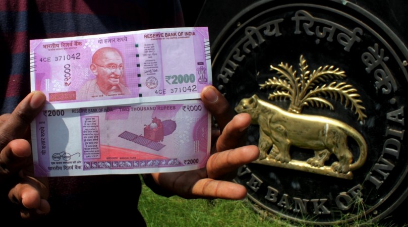 People show the new 2000 rupee currency note in Chennai on Nov. 10, 2016. rupee