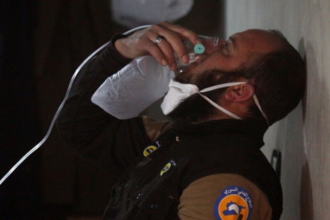 A civil defence member breathes through an oxygen mask after a suspected chemical attack in Syria. Syria chemical attack