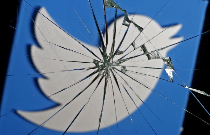 A 3D-printed Twitter logo is seen through broken glass, in this picture illustration taken February 8, 2016. Twitter