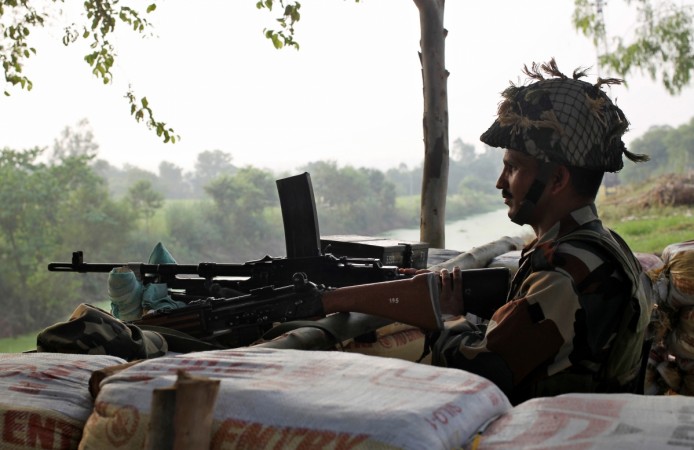 An Indian army soldier keeps guard from a bunker near the border with Pakistan An Indian army soldier keeps guard from a bunker near the border with Pakistan