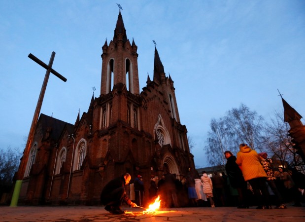 Clergymen and faithfuls gather outside the Roman Catholic Transfiguration Church. Clergymen and faithfuls gather outside the Roman Catholic Transfiguration Church during the Holy Saturday service
