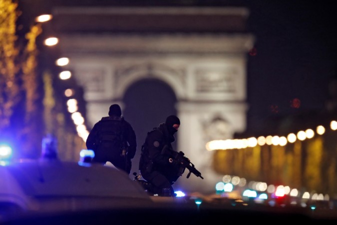 Masked police stand on top of their vehicle on the Champs Elysees Avenue Masked police stand on top of their vehicle on the Champs Elysees Avenue
