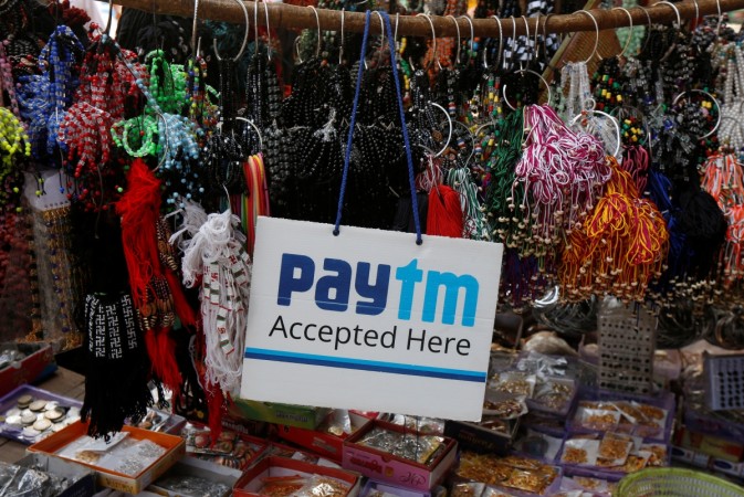 An advertisement of Paytm, a digital wallet company, is pictured at a road side stall in Kolkata, India, January 25, 2017. One97 communications, paytm, paytm to invest rs 12,000 crore, Softbank to invest in paytm, paytm digial wallet company, fintech companies in india, paytm investors