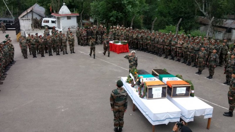 In picture: Soldiers pay homage to their two fallen compatriots whose bodies were mutilated by the Pakistani Army in the Krishna Ghati sector of Jammu and Kashmir. Indian martyrs