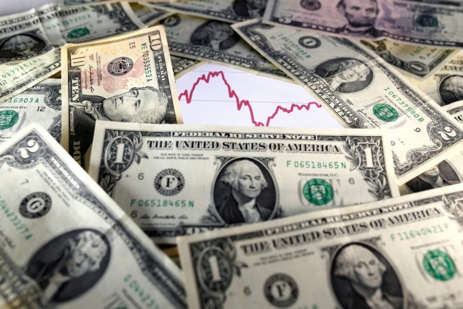 U.S. dollar notes are seen in front of a stock graph in this November 7, 2016 picture illustration. india forex reserves, fii buying, rbi data on foreign exchange reserves, fii debt buying, fii equity buying, indian stock markets, foreign investors in indian stock markets, pm modi, modi govt completes 3 years