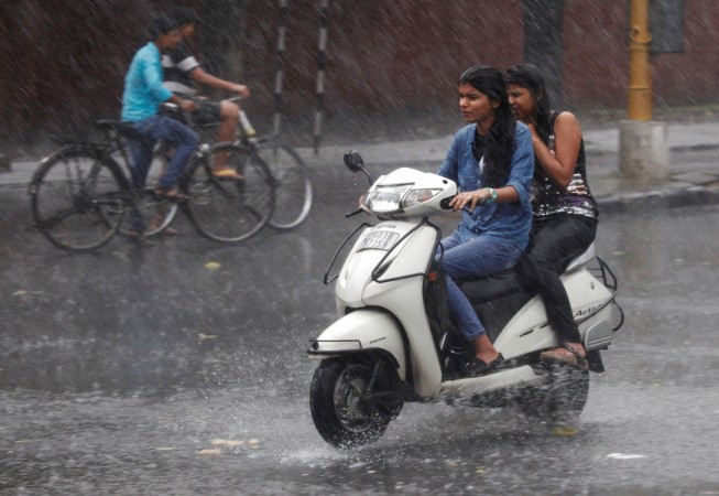 People commute during a heavy rain shower in Chandigarh, India, June 22, 2016. monsoon, rainfall, rain, imd, monsoon prediction, rainfall prediction, agriculture, farming, sensex, stock markets