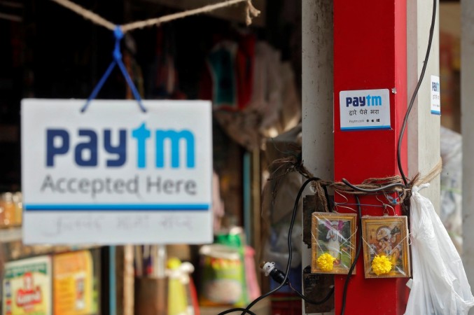 Advertisements of Paytm, a digital wallet company, are seen placed at stalls of roadside vegetable vendors in Mumbai, India, paytm, freecharge, paytm to acquire freecharge, snapdeal acquires freecharge, indian fintech companies, digital payments, digital wallet