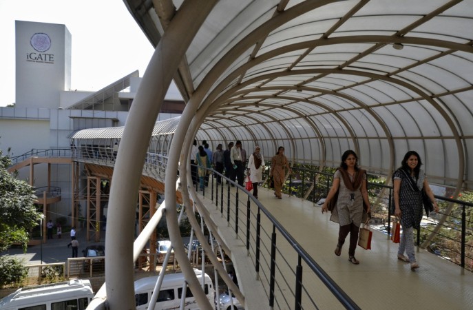 Employees cross an overpass at the Indian headquarters of iGate iGate