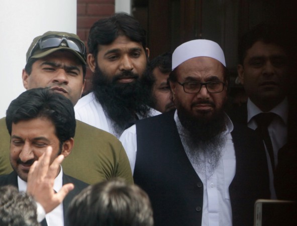 Hafiz Muhammad Saeed (R), chief of the Islamic charity organisation Jamaat-ud-Dawa (JuD), leaves after he appeared before a court to challenge his house arrest in Lahore, Pakistan, May 13, 2017. Hafiz Saeed