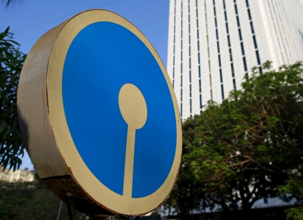 The logo of State Bank of India is pictured next to its headquarters in Mumbai, India, March 14, 2016. sbi bonus issue, sbi bonus history, sbi q4 results, sbi share price, state bank of india q4 results, sbi chairperson arundhati, sbi merger, sbi sensex