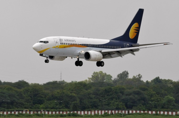 A Jet Airways passenger aircraft prepares to land at the airport in the western Indian city of Ahmedabad on August 12, 2013. Jet founder Naresh Goyal's expression of interest in the rescue plan has put the lenders in a fix. jet airways, jet airways etihad, emirates, emirates 2017 results, etihad emirates merger, gulf carriers hit by us rules, laptops banned to us flights