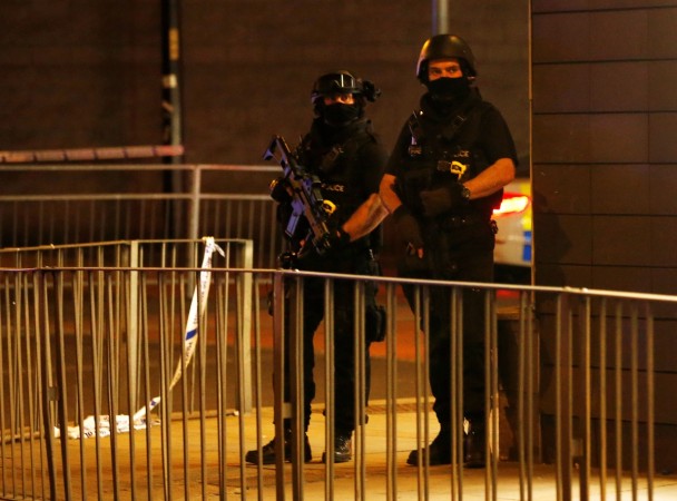 Armed police officers stand next to a police cordon outside the Manchester Arena, where U.S. singer Ariana Grande had been performing. Manchester Arena explosion