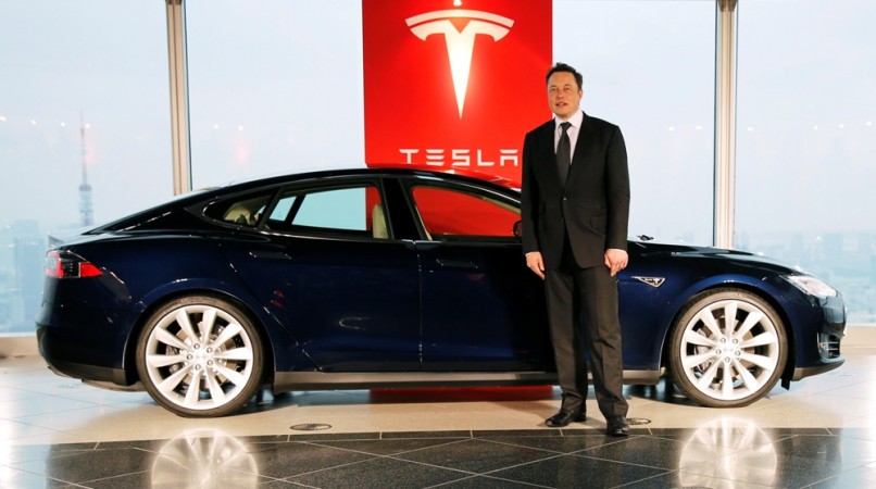 Tesla Motors Inc Chief Executive Elon Musk poses with a Tesla Model S electric car in Tokyo September 8, 2014. Tesla Motors, tesla motors India, Elon Musk