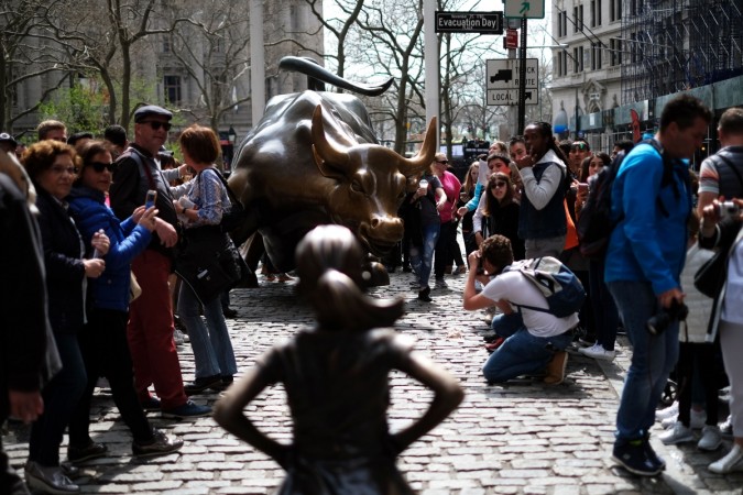 Fearless Girl stares up at the Charging Bull at Wall Street. Fearless Girl