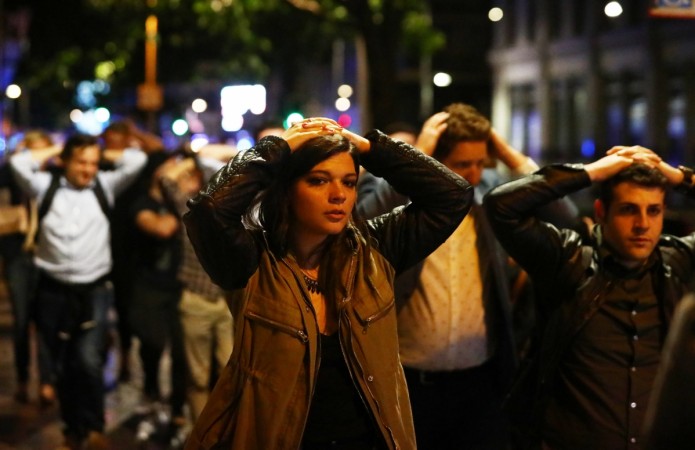 People leave the area with their hands up after an incident near London Bridge in London, Britain June 4, 2017. London Attack