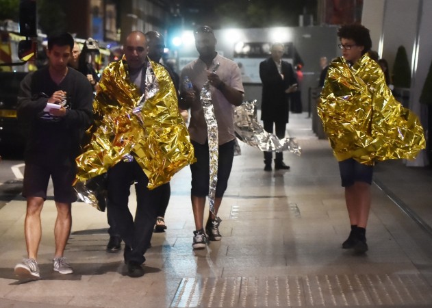 People leave the area wearing foil blankets after an incident near London Bridge in London, Britain June 4, 2017. London