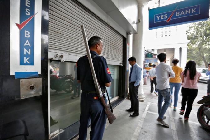 A security guard stands outside a closed Yes Bank branch in New Delhi. yes bank, yes bank under reported npas, bad loans of yes bank, yes bank share price, yes bank annual report