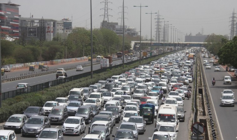Motorists stuck in a traffic jam on Delhi- Gurugram Expressway in Gurugram on June 5, 2017. cars, car sales, traffic jam, vehicles, pv sales, pollution