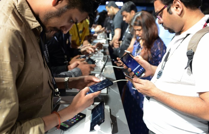 People look at the newly launched Samsung Galaxy S8 and Galaxy S8 smartphones during an event in New Delhi on April 19, 2017. Samsung India