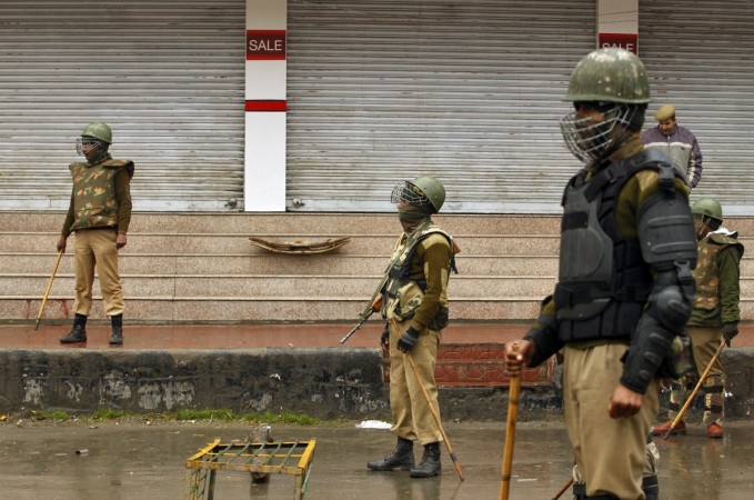 The man, identified as Rahul Basan went missing from the Mattan temple Indian policemen stand guard at a barricade setup during curfew of an area in Srinagar