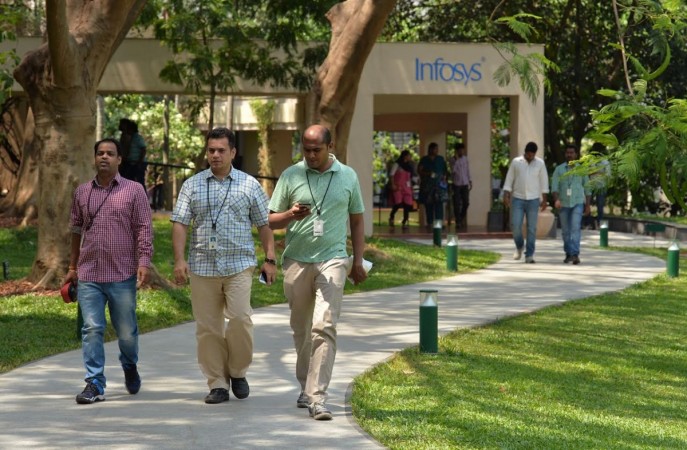 Employees of Infosys Technologies Limited walk in the campus of the company's headquarters in Bangalore on April 13, 2017. Indian software giant Infosys has pledged to return USD2 billion to shareholders this year as it reported subdued growth in profits for the fourth quarter. infosys, infosys layoff, infosys hiring, it jobs, vishal sikka