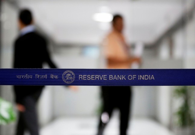 People walk past a barricade inside the Reserve Bank of India (RBI) headquarters in Mumbai in this June 7, 2017 file photo. REUTERS/Shailesh Andrade RBI