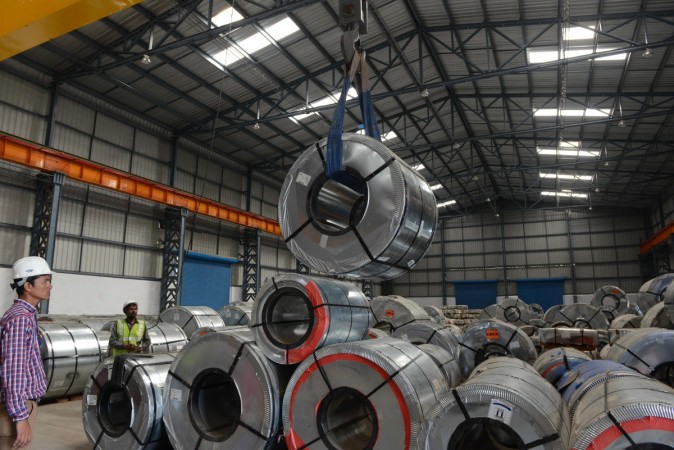 Indian workers store steel coils unloaded from an Indian Railways train at a new private freight terminal in Sachana village near Viramgam, some 50 kms from Ahmedabad on January 27, 2016. steel production in india, steel production japan, steel exports by india, steel imports by india, india news, steel, tata steel, factory, iip, indian economy, gdp