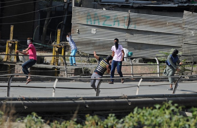 In picture: Kashmiri protestors throw stones towards Indian government forces in clashes during a protest against the death of civilians in Kashmir's ongoing summer unrest, in Srinagar on October 7, 2016. Stone pelters