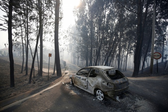 A burned car is seen in the aftermath of a forest fire near Pedrogao Grande, in central Portugal, June 18, 2017. Portugal Fire