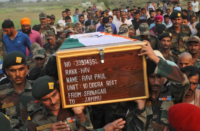 Indian army soldiers carry a coffin containing the body of Ravi Paul, who was killed in Sunday's attack at an Indian army base in Kashmir's Uri, during his funeral in Sarwa village in Samba district, south of Jammu, September 19, 2016. Uri Attack