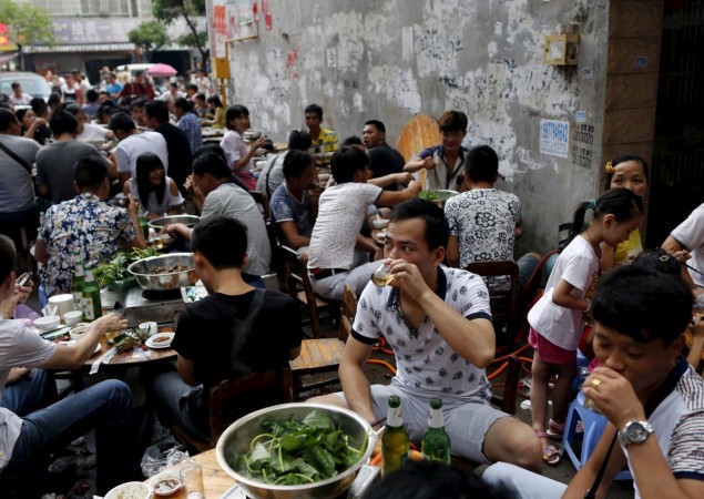 People eat dog meat at a dog meat restaurant district on the day of local dog meat festival in Yulin, Guangxi Autonomous Region, June 22, 2015. Yulin Festival