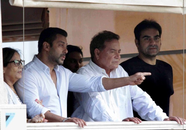 Indian Bollywood actor Salman Khan (2L), mother Salma, (L), father Salim Khan (2R) and Arbaaz Khan stand on the balcony on arrival at his house in Galaxy Apartment after getting bail from his ongoing trial of hit and run case, in Mumbai on May 8, 2015. Salman Khan