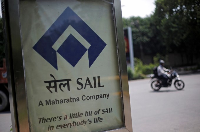 A motorcyclist rides past an advertisement of Steel Authority of India Ltd. (SAIL) at a street in New Delhi, India, August 5, 2016. gst, sail ready for gst, gst rollout, gst implementation, steel, steel companies in india