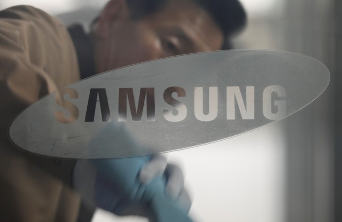 A worker wipes a glass panel before the Samsung Electronics general meeting of shareholders at a company's building in Seoul, South Korea, March 24, 2017. Samsung