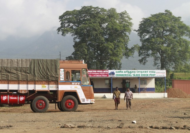 Truck drivers walk out of a Commercial Taxes Department check post after getting clearance to cross a checkpoint with their goods at the Chavadi checkpoint on the outskirt of Coimbatore in Tamil Nadu in this September 5, 2015 file photo. The GST rollout was supposed to sweep away hundreds of checkposts on India's state borders, paving the way for the seamless movement of goods from the tropical south to the Himalayas in the north. But political opposition and the dilution of some of the tax's key tenets mean hopes are fading that the checkposts will be demolished any time soon, a major blow for Prime Minister Narendra Modi's reform agenda. REUTERS/Sivaram V GST