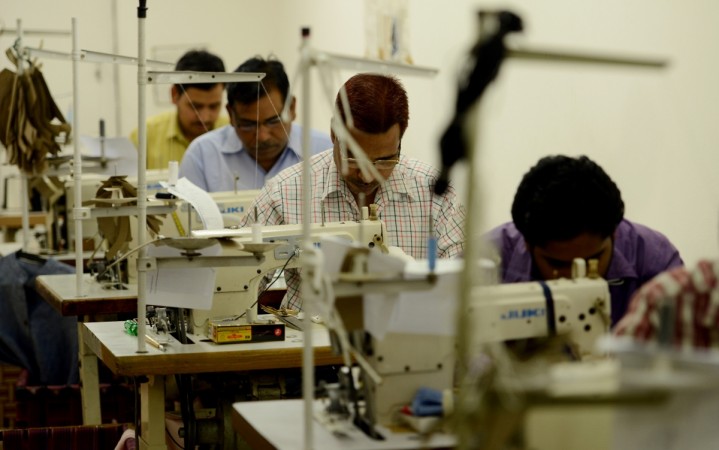 In this picture taken on June 22, 2017, Indian workers at Fable Street, a women's clothing brand, stitch fabric at their workshop in New Delhi. gst. gst all you need to know, gst rates, gst how to register, gst registration, gst exemption, gst midnight session