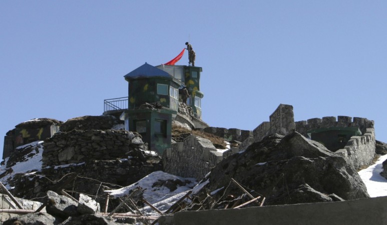 Chinese soldiers put up a flag atop their post at the India-China trade route at Nathu-La, 55 km (34 miles) north of Gangtok, the capital of India's northeastern state of Sikkim, January 17, 2009. Sikkim India China