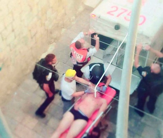 In picture: An injured Magav personnel is treated after a terror attack in Jerusalem on Friday, July 14, 2017. Israel terror attack