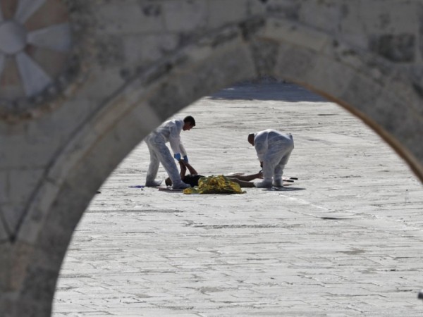 In picture: The bodies of one of those killed in the Jerusalem terror attack on Friday, July 14, 2017, is being removed. Jerusalem terror attack